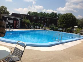Milford apartment for rent - a swimming pool in front of a hotel on a sunny day