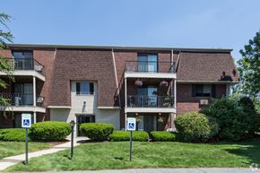 Milford apartment for rent - an apartment building with parking signs in front of it