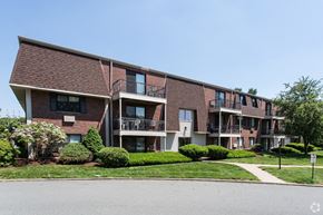 Milford apartment for rent - a brick apartment building with balconies and a sidewalk
