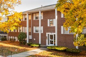 Milford apartment for rent - a brick building with trees in front of it