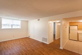 Milford apartment for rent - an empty living room and kitchen with a refrigerator and