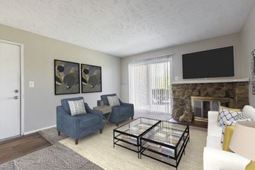 Omaha apartment for rent - a living room with a fireplace and a glass coffee table