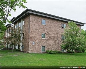 St. Paul apartment for rent - a brick building with green grass and trees
