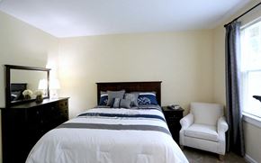 Nashua apartment for rent - a bedroom with a bed and a chair and a dresser