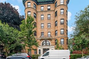 Cambridge apartment for rent - a large brick building with cars parked in front of it