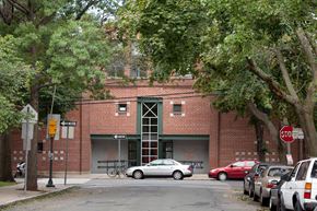 Cambridge apartment for rent - a red brick building with cars parked in front of it