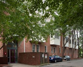 Cambridge apartment for rent - a brick apartment building with cars parked in front of it
