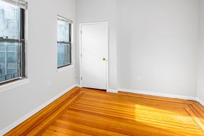 Cambridge apartment for rent - a living room with wood floors and a white door