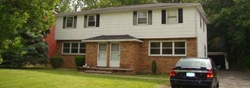 Amherst triplex for rent - a car parked in front of a house
