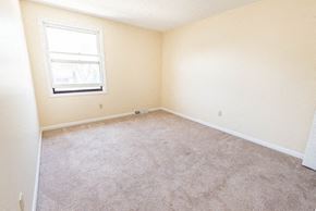 Amherst triplex for rent - an empty room with carpet and a window