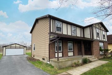 Amherst triplex for rent - A two-story house with a garage on the left.