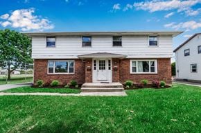 Williamsville triplex for rent - a home with a white door and red brick facade