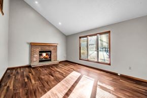 Depew house for rent - the living room of a house with a fireplace and wooden floors