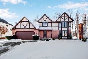 Depew house for rent - a red brick house with a garage in the snow