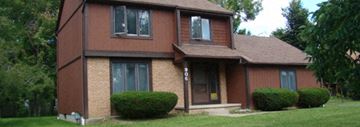 Williamsville house for rent - A brown house with a white door and windows.