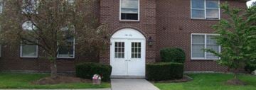 Amherst condo for rent - a white door in front of a brick building