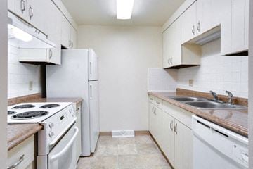 Amherst condo for rent - A kitchen with white appliances and cabinets.