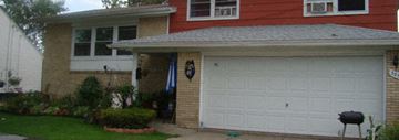 Tonawanda house for rent - A red house with a white garage door.