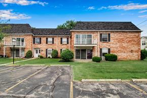 Amherst condo for rent - A brick building with a parking lot in front.