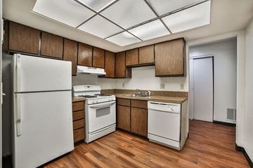 Amherst condo for rent - a kitchen with white appliances and wooden cabinets