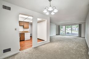 Amherst condo for rent - an empty living room and kitchen with a sliding glass door