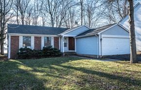 Amherst house for rent - the front of a white house with a lawn and trees