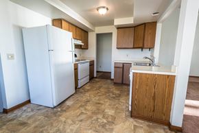 Amherst house for rent - a kitchen with white appliances and wooden cabinets and a white refrigerator