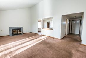 Amherst house for rent - a living room with a fireplace and a carpeted floor