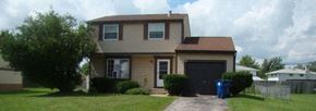 Amherst house for rent - A house with a brown roof and a black garage door.