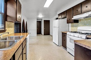 Tonawanda house for rent - a kitchen with a stove and a sink