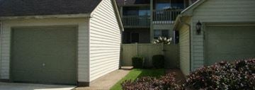 Amherst townhouse for rent - A white house with a green garage door.
