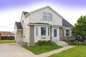 Tonawanda house for rent - A house with a grey roof and a white door.