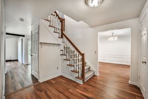 Amherst house for rent - a staircase in a house with wood floors and white walls