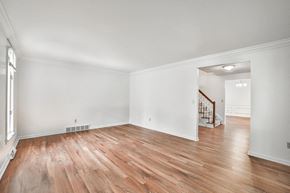 Amherst house for rent - the living room and dining room with hardwood floors and white walls