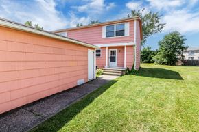 Amherst triplex for rent - A pink house with a white door and windows.