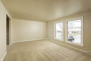 Amherst house for rent - A room with a carpeted floor and two windows.