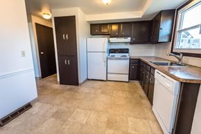 Amherst triplex for rent - a kitchen with white appliances and black cabinets