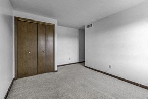 Amherst triplex for rent - a bedroom with a closet and a carpeted floor