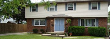 Amherst triplex for rent - A house with a blue door and a grey roof.