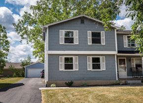 Amherst triplex for rent - a blue house with white windows and a driveway