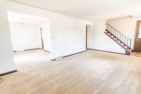 Amherst triplex for rent - an empty living room with a staircase in a house