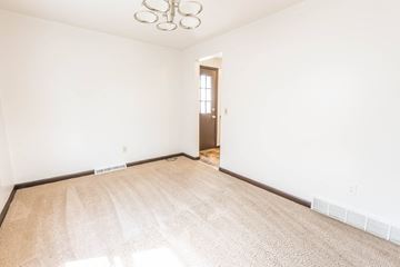 Amherst triplex for rent - a living room with a rug and white walls