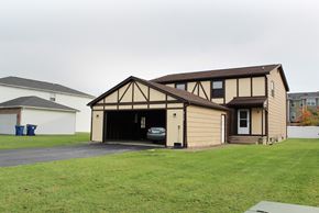 Amherst triplex for rent - a garage with a car parked inside of it