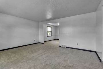 Amherst triplex for rent - the living room of a new home with white walls and carpet