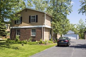 Amherst triplex for rent - A house with a car parked in front.