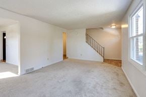 Amherst triplex for rent - A spacious room with a staircase and a window.