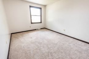 Amherst triplex for rent - a room with a carpeted floor and a window