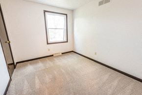 Amherst triplex for rent - a room with a carpeted floor and a window