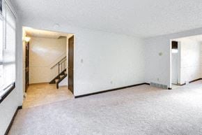 Amherst triplex for rent - an empty living room with white walls and a staircase
