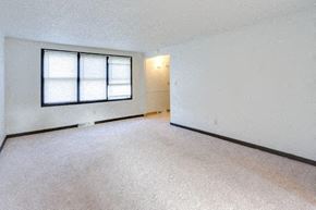 Amherst triplex for rent - an empty room with a window and a white wall